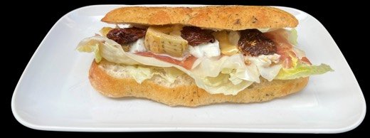 Panino mit Prosciutto, Mozzarella und Salat auf einem weissen Teller.